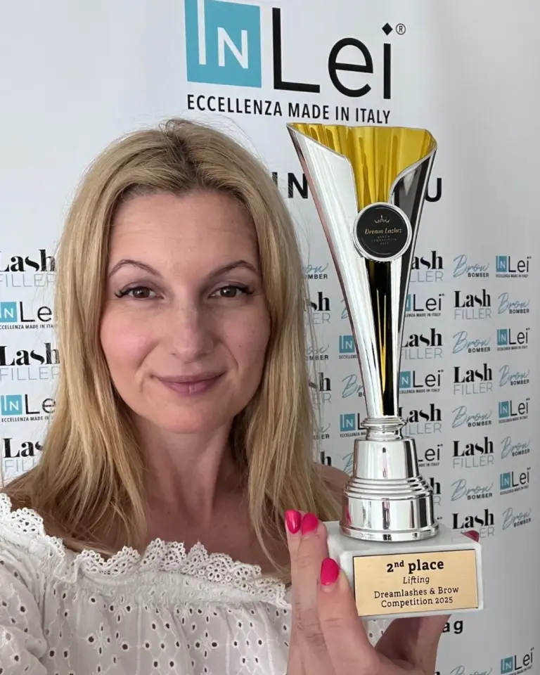 Nikoletta Tóth-Kiss holds a trophy for second place in the 2025 Dreamlashes & Brow Lifting Competition.